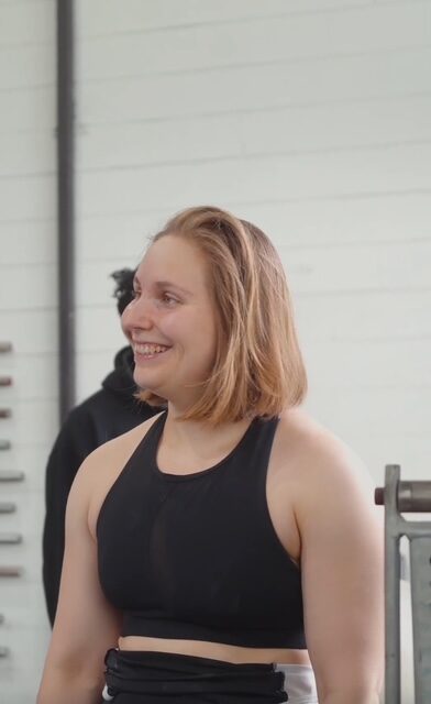 A smiling woman mid-training session